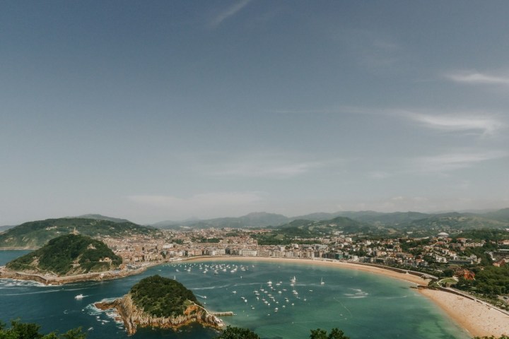 Coastal city with beaches, small islands, and boats in the bay.